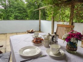 A photo of breakfast set up on a patio, with greenery in the background